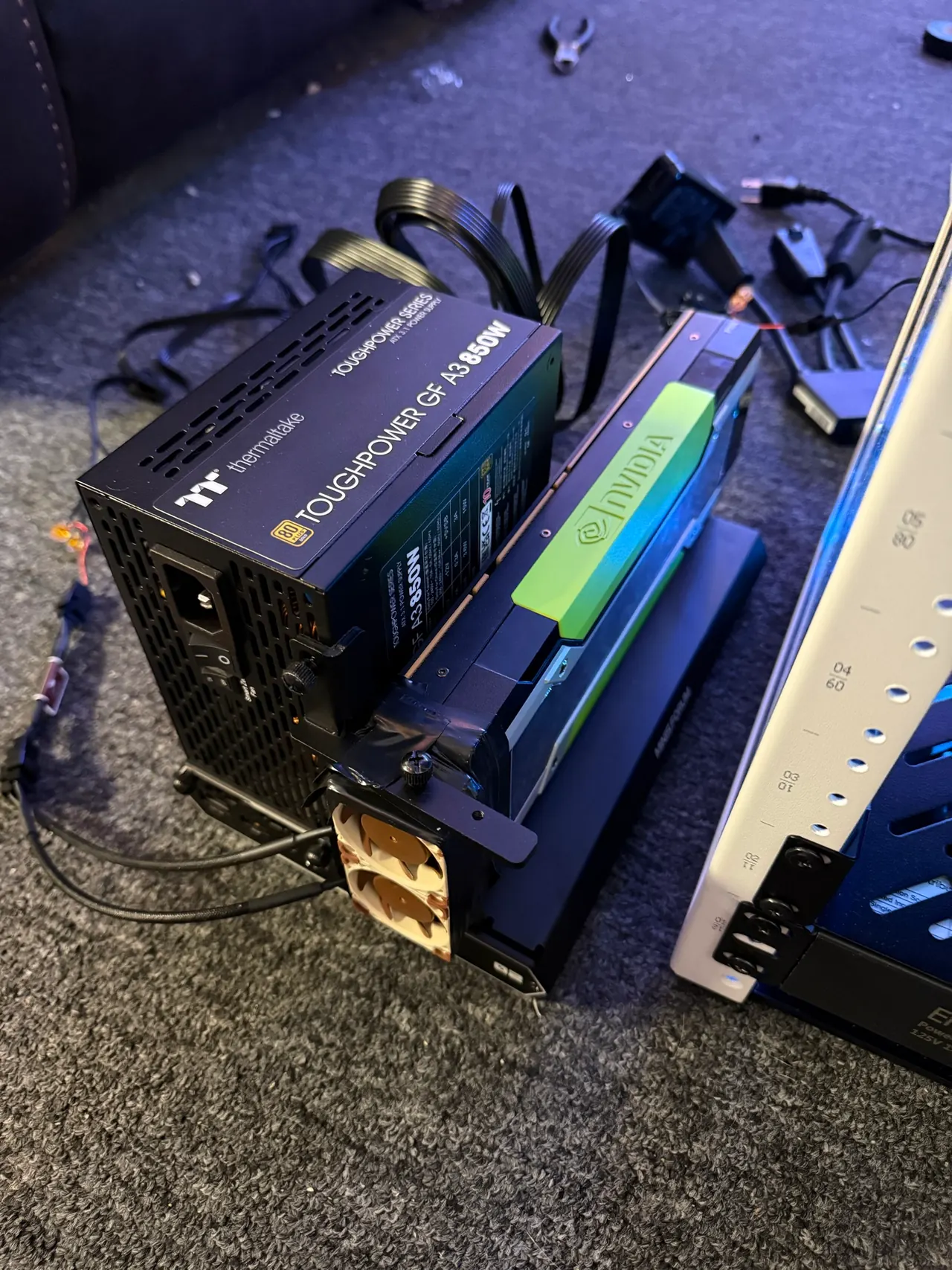 The external GPU bench with a graphics card, power supply, cables, and cooling fans.