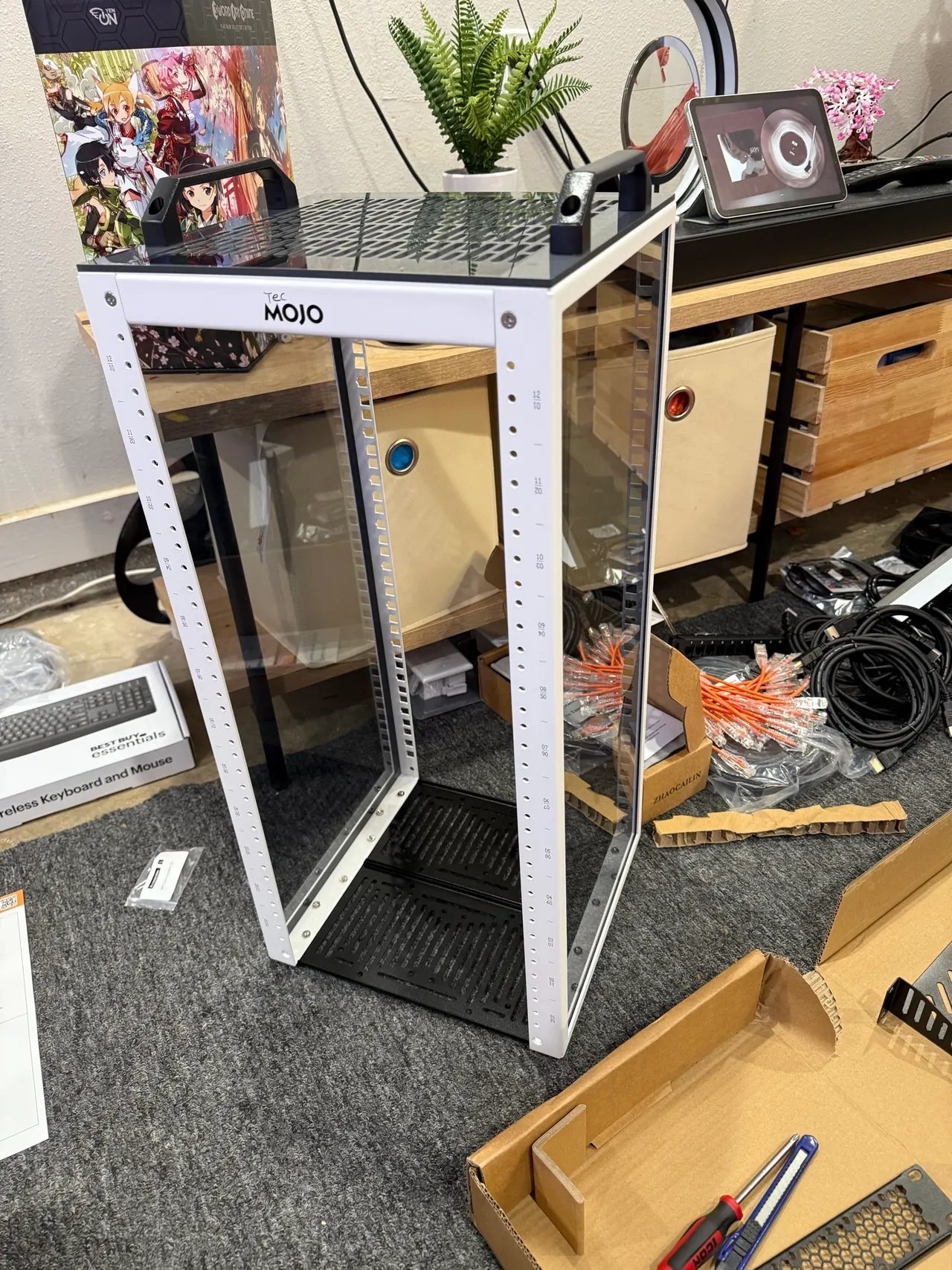 The empty TecMOJO rack frame being assembled on the floor.